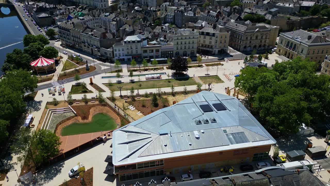 Drone circling above newly renovated 11 Novembre Square in Laval, with new hall, fountains and carousel. Mayenne in France