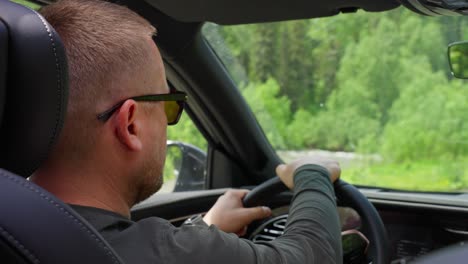 man driving through scenic mountain road
