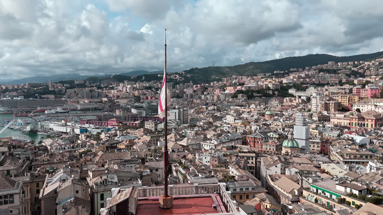 Waving St. George's Cross Flag atop Grimaldina tower, aerial slomo view