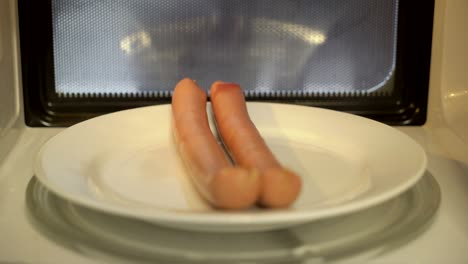 using microwave to heat up food. cooking sausages