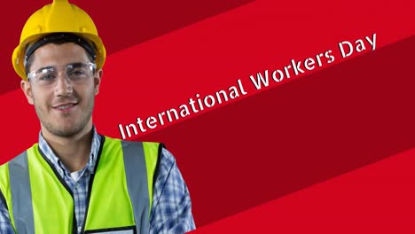 animation of smiling caucasian male worker over international workers day text