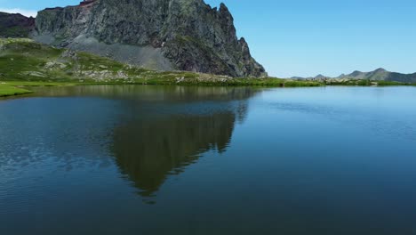 Over-the-water-video-from-a-drone-above-a-mountain-lake-during-summer