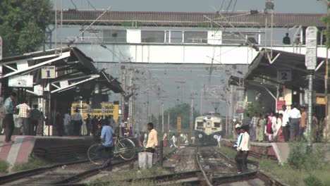 people walk back and forth across railroad tracks 1