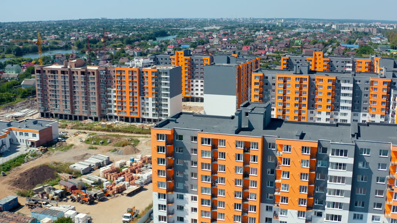 New city complex. Tall urban apartment buildings with colorful walls. Residential area with newly built multi-storey houses. Aerial view.