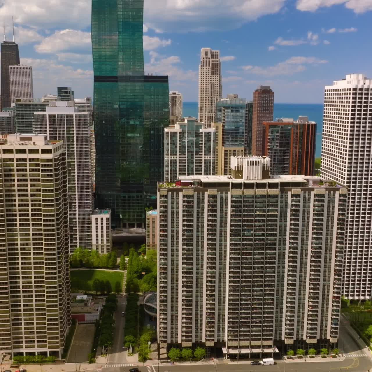 Multi-storied buildings and skyscrapers on beautiful sunny day. Fantastic Chicago architecture at the backdrop of blue sky and blue lake water