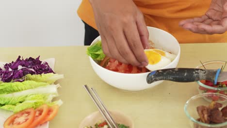 preparing a delicious bowl of instant noodles with egg and fresh vegetables