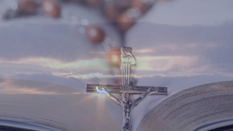 bible open with crucifix and rosary beads, gentle light creating serene animation