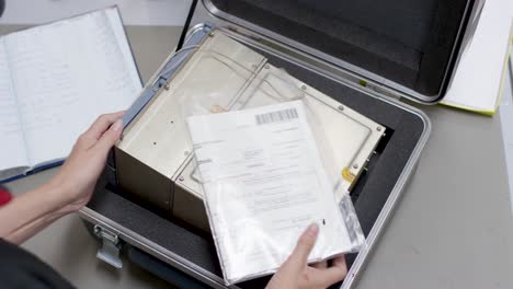 person handling technical equipment in a protective case