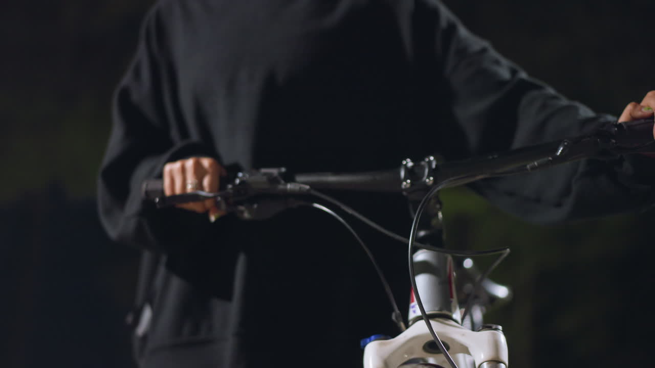 Cyclist Travels Nocturnally, Urban Cyclist Swiftly Moves Under Glow Of Streetlights During Night, Nightly Bicycle Ride Accelerating Through Illuminated City Streets With Speed And Purpose