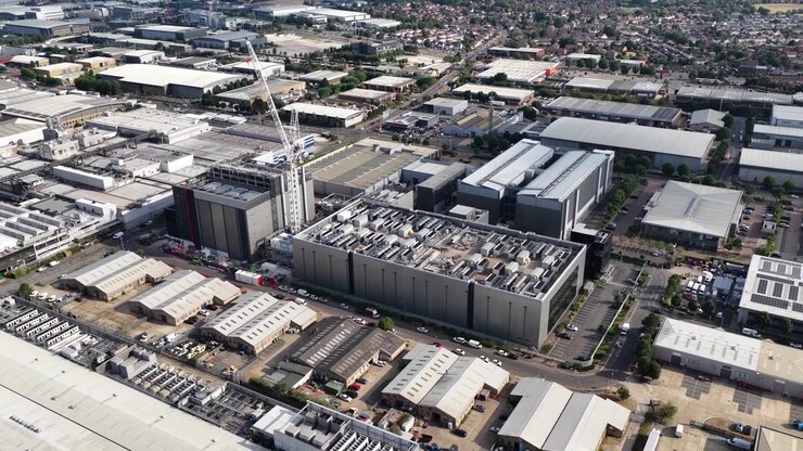 Aerial drone view of a large data center under construction in Slough, UK, showing infrastructure for AI computing, cloud services, servers, cooling and big data processing