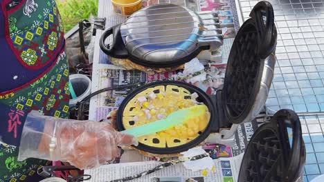 street food vendor making corn waffles