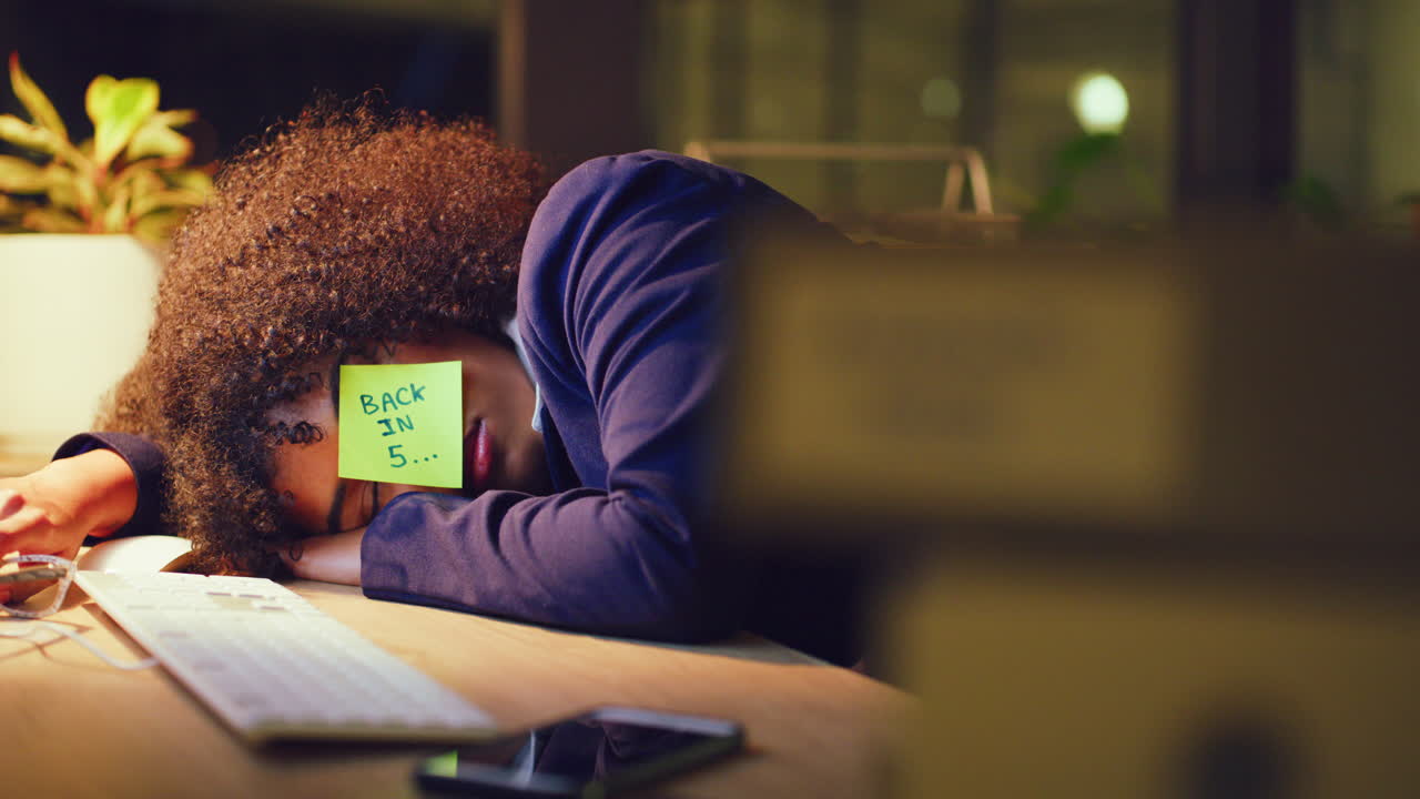 Overworked business woman sleeping at a desk