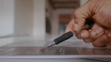 unemployed man in search of job controlling his cv with a pen in his hand