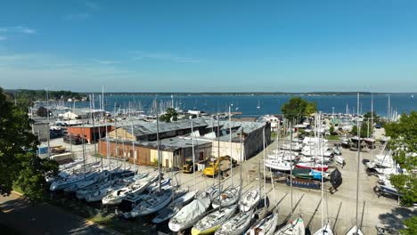 Smooth-rise-and-tilt-to-show-the-boatyard,-marina,-and-lake-beyond