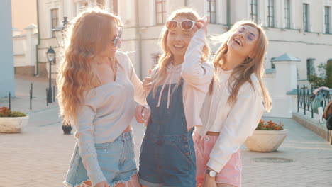 three happy friends laughing outdoors