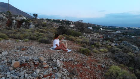 caucasian female drinking water with beautiful sunset