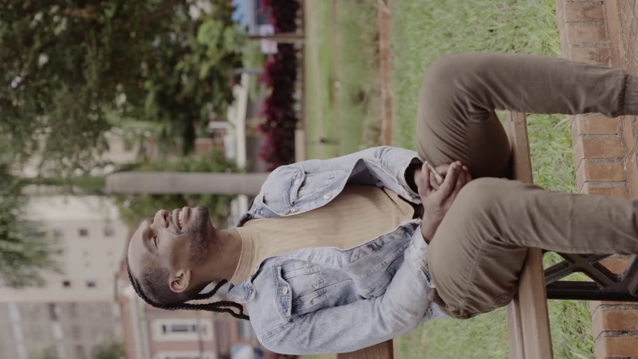 Young man relaxing on a park bench