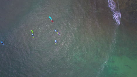 Raising-up-aerial-view-of-surfers-learning-to-surf-off-the-coast-of-Hale'iwa-Oahu-Hawaii-North-Shore