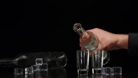 man pouring vodka shots