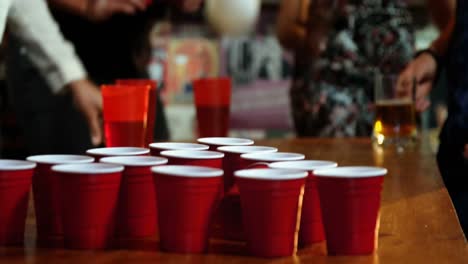 Friends-playing-with-ball-in-bar