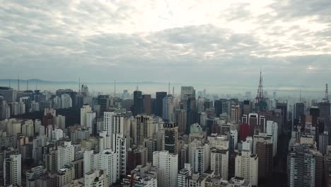 stunning flight over city centre in sunrise, aerial 4k foggy dramatic morning shot