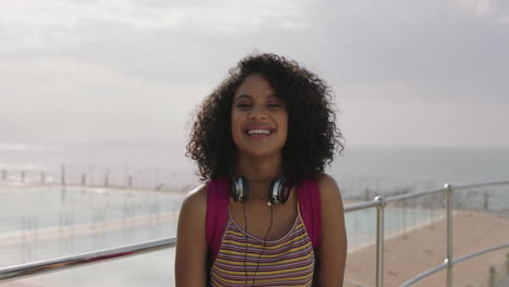 portrait of beautiful happy hispanic woman with afro removes sunglasses laughing cheerful