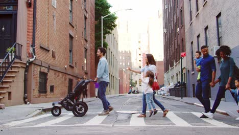 two young families crossing a street in brooklyn