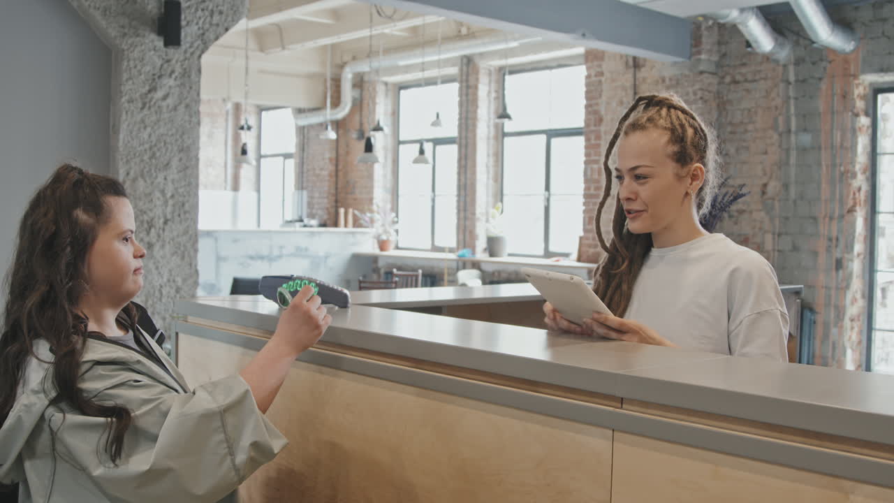 Young Woman With Down Syndrome Registering At Yoga Studio