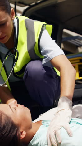 ambulance team treating a woman