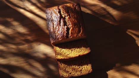 flat lay of sliced spiced pumpkin bread on wooden table