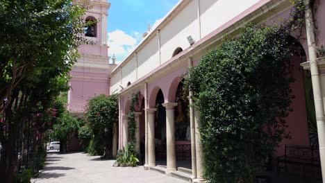 Panning-view-from-street-level-arches-at-Cathedral-Basilica-of-Salta,-to-view-of-tower-above