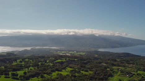 slow pan left aerial drone footage of tahiti island from mountain top