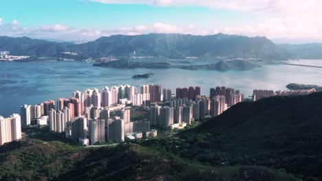 Coastal-town-revealed-behind-Ma-On-Shan-mountains-on-mystical-sunny-day