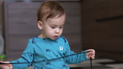 baby exploring a string