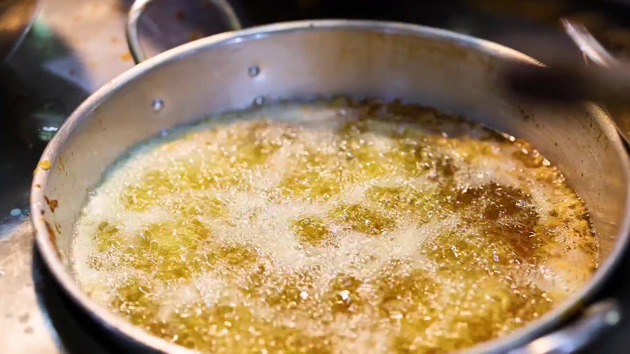 Oil boiling in a pot at market