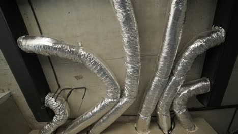 industrial ceiling with a network of insulated ductwork, showcasing the complexity and functionality of hvac systems in a modern building infrastructure