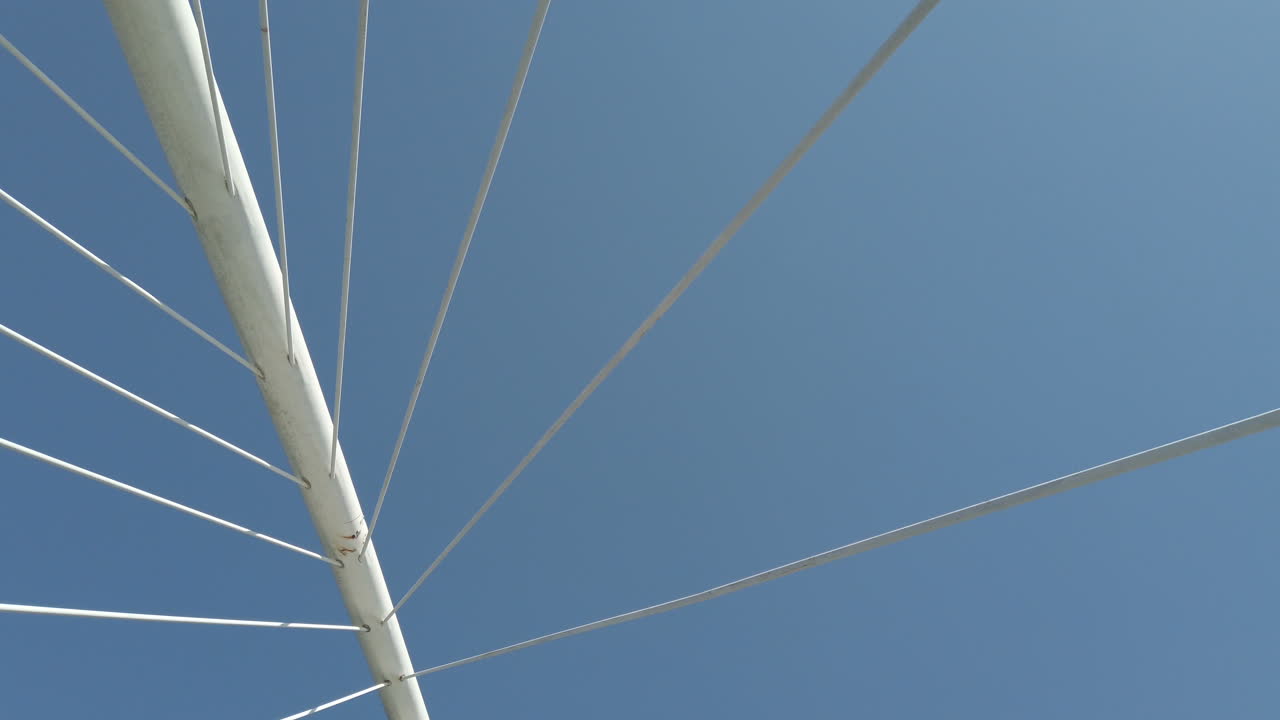 Abstract view of a bridge against a clear blue sky