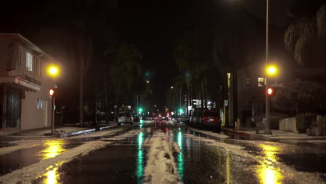 snow in the middle of the street with palm trees in downtown santa barbara california unusual weather