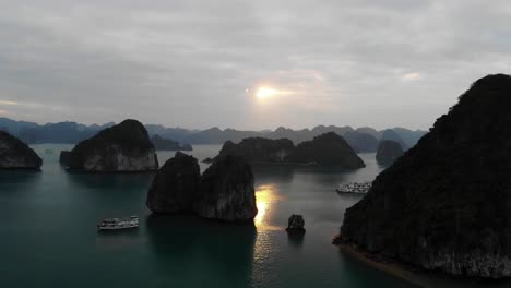 aerial sunset of ha long bay vietnam, little rocky islet scenic archipelago with cruise yacht boat sailing for explore and excursion