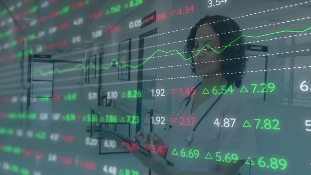 Stock market data animation over healthcare professional using tablet in hospital corridor