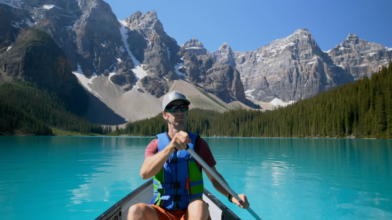 Man rowing a boat in river at countryside 4k