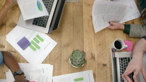 Overhead-View-People-Working-Together-At-Table