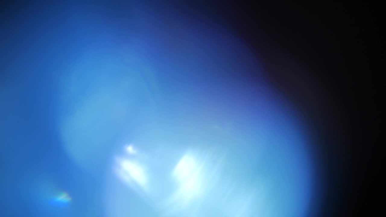 Transizione di riflesso lente blu brillante su sfondo nero