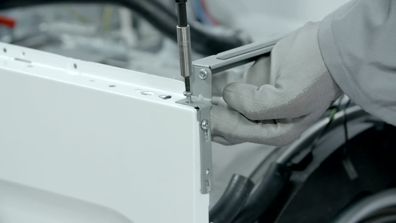 Unplugging screws that hold parts of washing machine