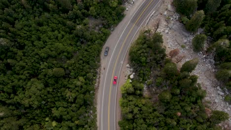 aerial view of red convertible 1958 chevrolet impala driving big cottonwood canyon scenic drive in utah, usa