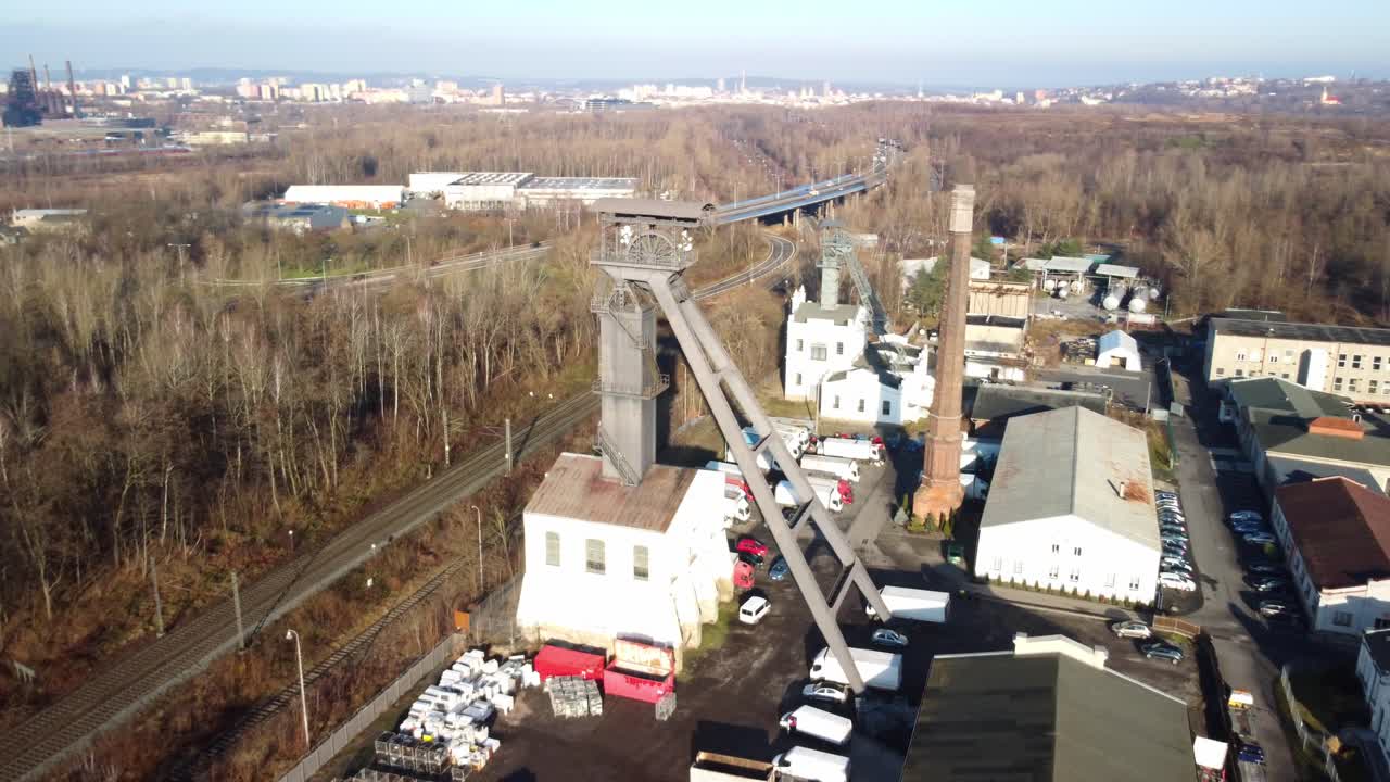 Alexander Coal Mine Surrounded By Fall Trees With Nearby Railway In Ostrava, Czech Republic. aerial shot