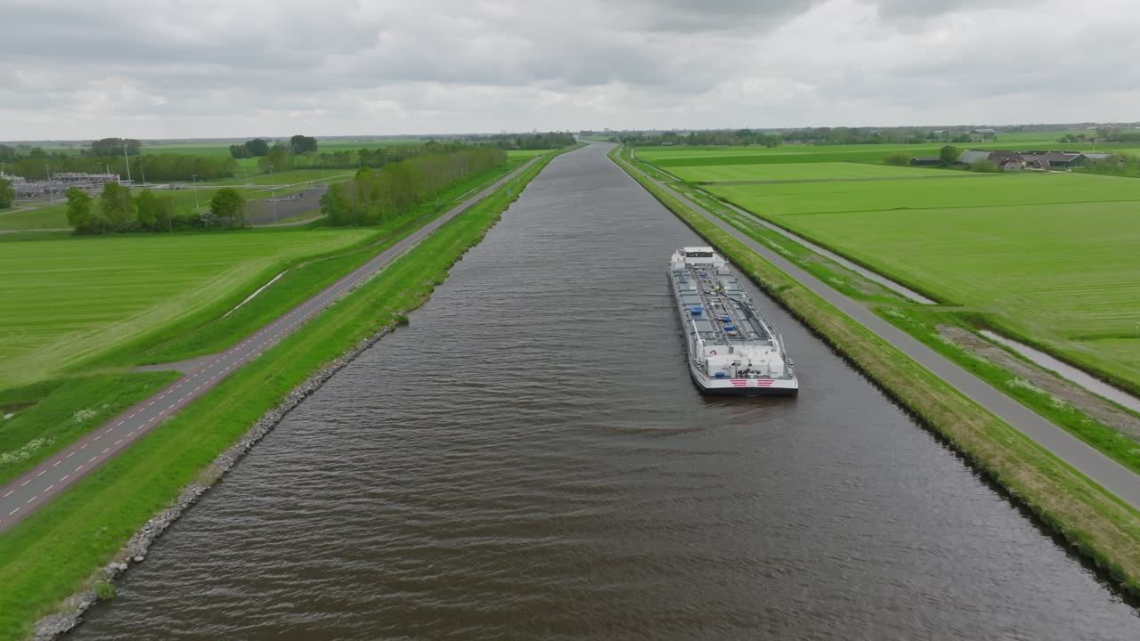 Nadir shot of the bridge deck as a car drives across the bascule span; control huts and fender lines visible