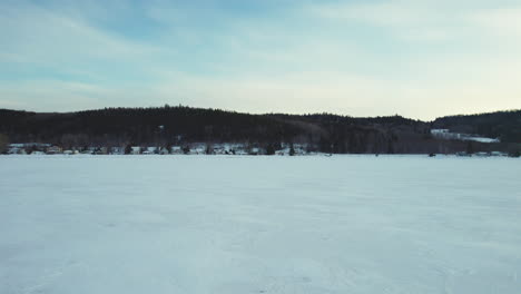 flying drone above a frozen lake in canada