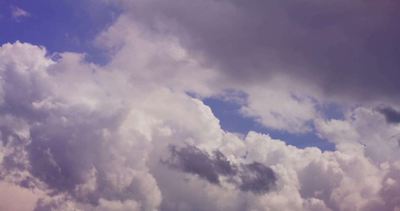 Fluffy White Clouds Drifting Across a Clear Blue Sky