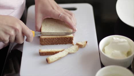 Cutting the crust out of bread slices